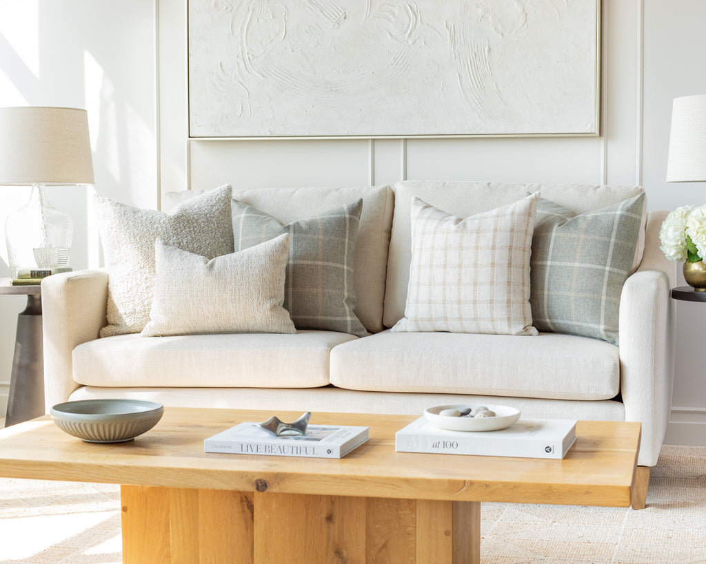 Cream and Grey Sofa Pillow Pairing: a combination of cream and grey throw pillows mixing a variety of classic plaid checks with ultra textured solids