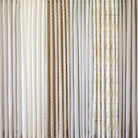 Tonic Living shower curtain collection featuring neutral linen curtains in ivory, beige, stripe, and soft botanical patterns.