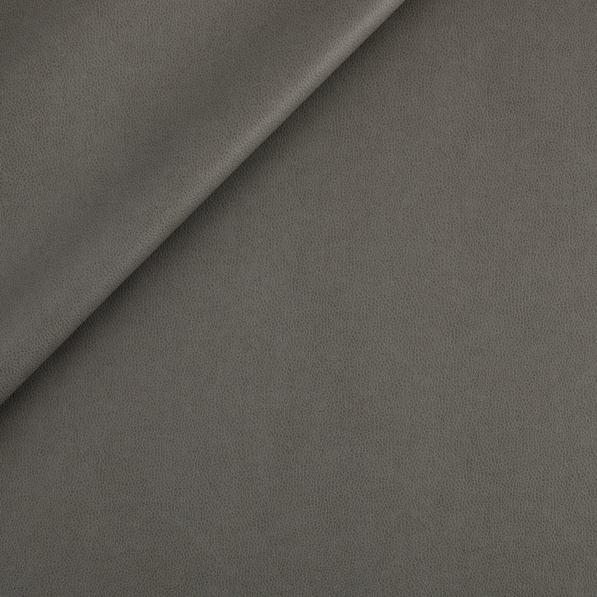 Tonic Living Smythe Faux Leather Fabric in Charcoal, a dark grey performance upholstery fabric with the rich character of genuine leather.