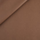 Tonic Living Smythe Faux Leather Fabric in Cognac, a deep brown performance upholstery fabric with the rich character of genuine leather.