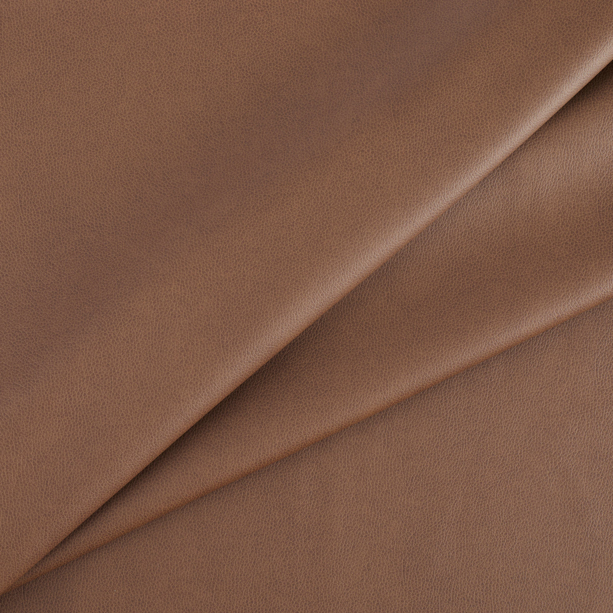 Tonic Living Smythe Faux Leather Fabric in Cognac, a deep cognac brown high-performance upholstery fabric with a natural leather look.