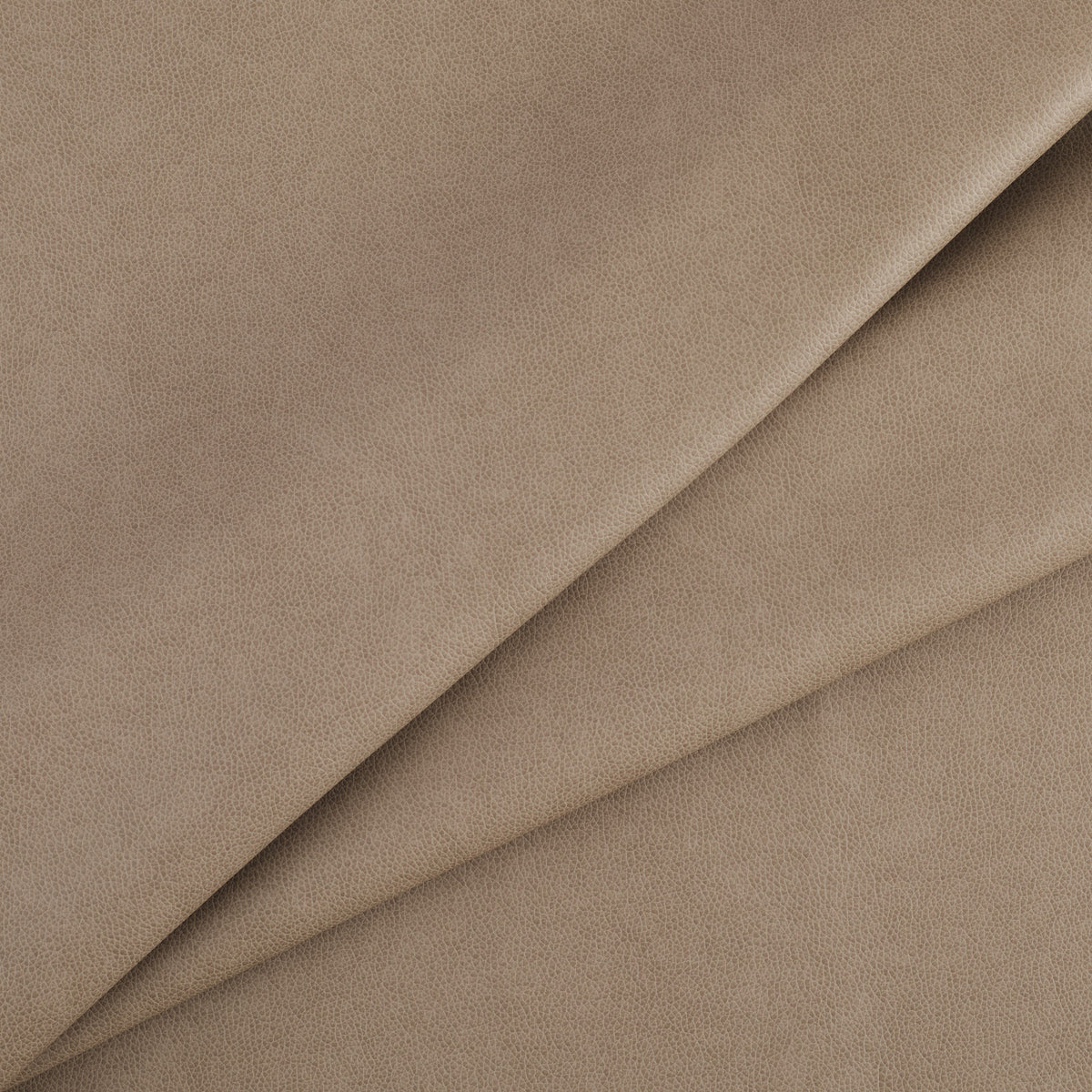 Tonic Living Smythe Faux Leather Fabric in Portobello, a taupe brown high-performance upholstery fabric with a natural leather look.