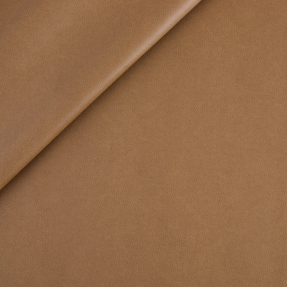 Tonic Living Smythe Faux Leather Fabric in Saddle, a brown performance upholstery fabric with the rich character of genuine leather.