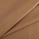 Tonic Living Smythe Faux Leather Fabric in Saddle, a saddle brown high-performance upholstery fabric with a natural leather look.