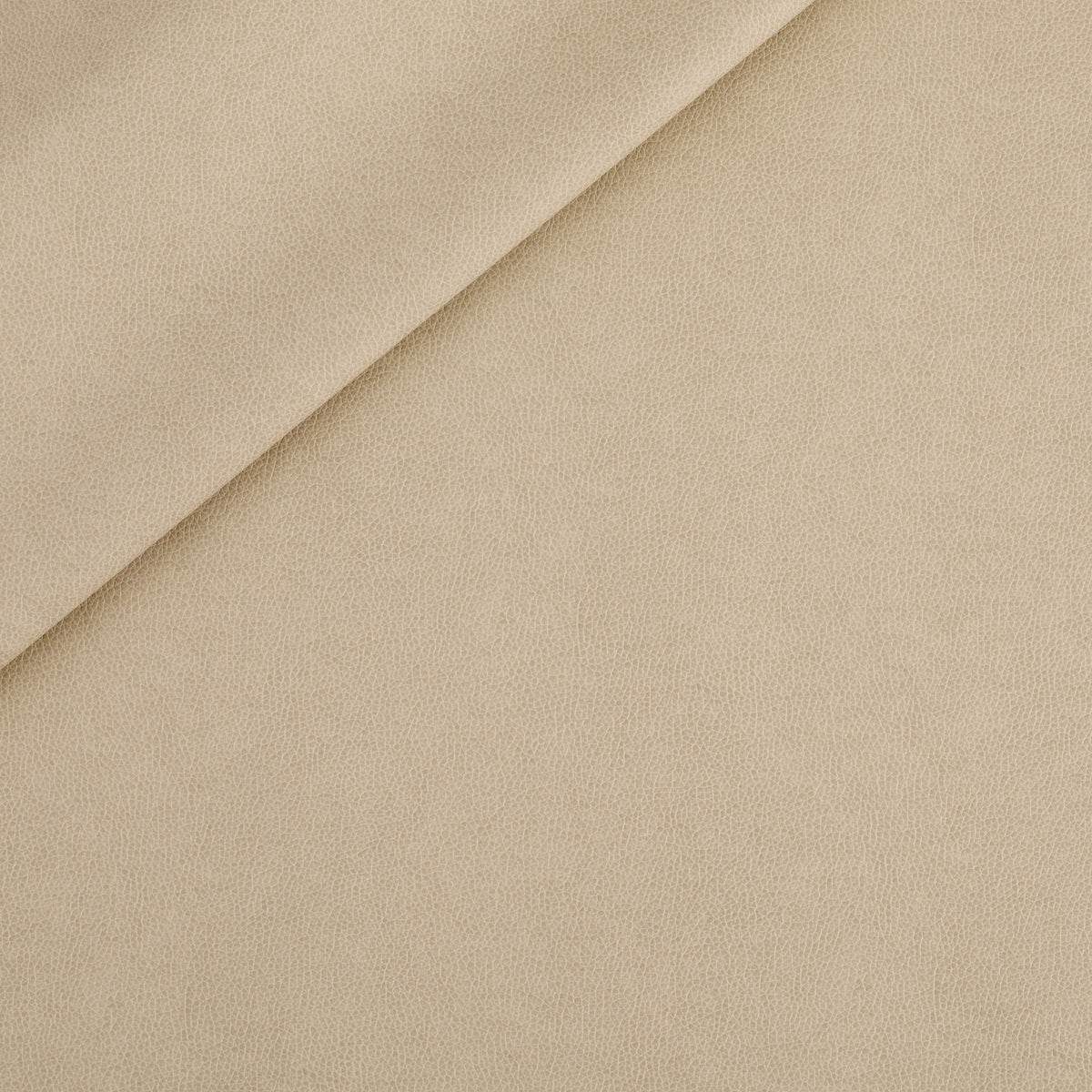 Tonic Living Smythe Faux Leather Fabric in Sandstone, a beige performance upholstery fabric with the rich character of genuine leather