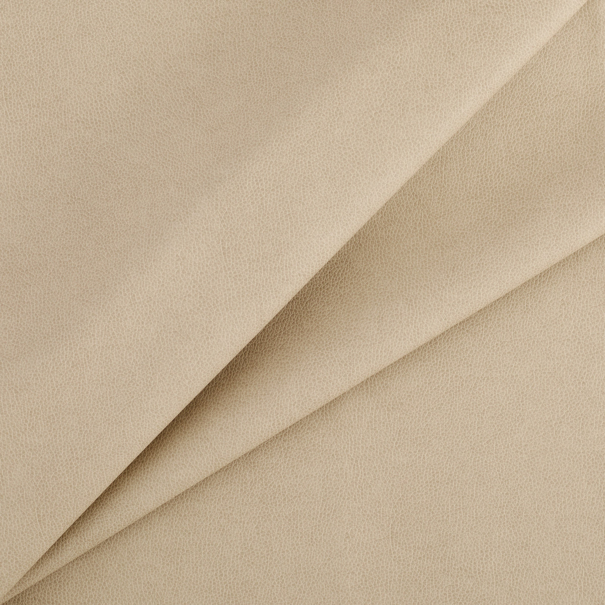 Tonic Living Smythe Faux Leather Fabric in Sandstone, a sandy beige high-performance upholstery fabric with a natural leather look.