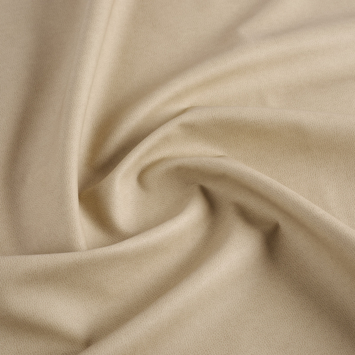 Tonic Living Smythe Sandstone high-performance faux leather fabric featuring a warm neutral beige colour and natural-looking grain.