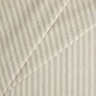 Tonic Living Somerset Stripe Oatmeal upholstery fabric featuring a classic sand and beige striped design.