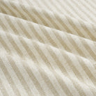 Tonic Living Somerset Stripe Oatmeal fabric featuring a timeless light oatmeal and beige vertical stripe pattern.
