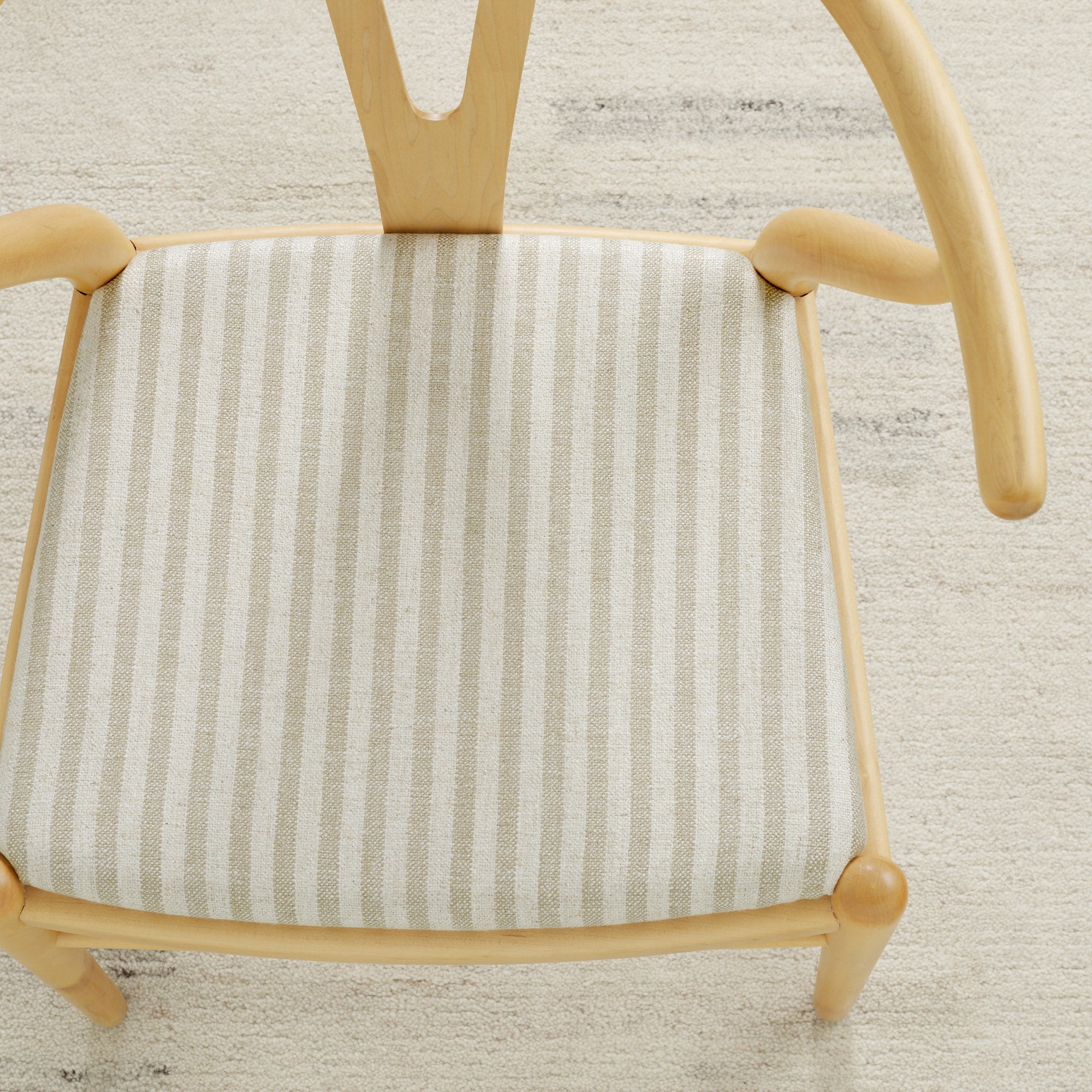 Tonic Living Somerset Stripe Oatmeal upholstery fabric on a dining chair seat in sand and beige stripe.