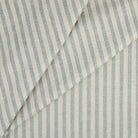 Tonic Living Somerset Stripe Sky Blue upholstery fabric featuring a classic blue and beige striped design.