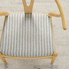Tonic Living Somerset Stripe Sky Blue upholstery fabric on a dining chair seat in blue and beige stripe.