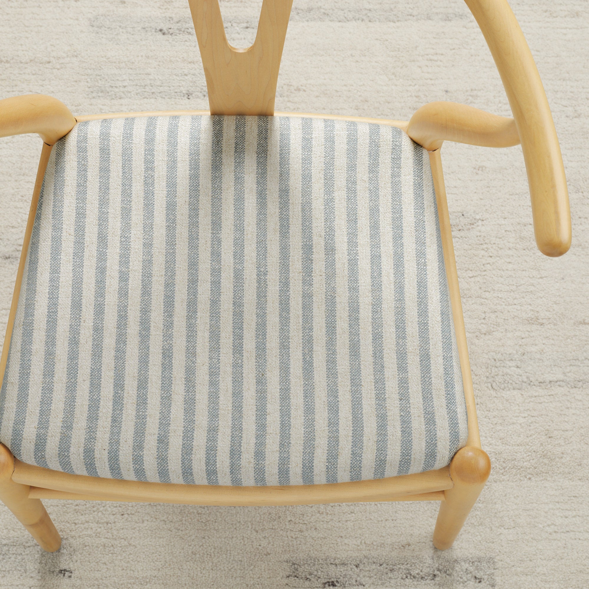 Tonic Living Somerset Stripe Sky Blue upholstery fabric on a dining chair seat in blue and beige stripe.