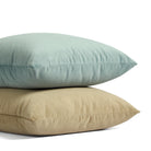 Stack of Tonic Living Sterling Velvet pillows in Lake aqua blue and Bark warm brown velvet.