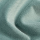 Close up of Tonic Living Sterling Velvet Lake fabric showing aqua blue velvet, fine linear texture, and luminous colour variation.