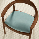 Tonic Living Sterling Velvet Lake blue upholstery fabric shown on a dining chair seat with a luxurious velvet finish.