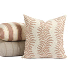Tonic Living Swoon Terracotta decorative pillow styled in front of cream and terracotta cushions.