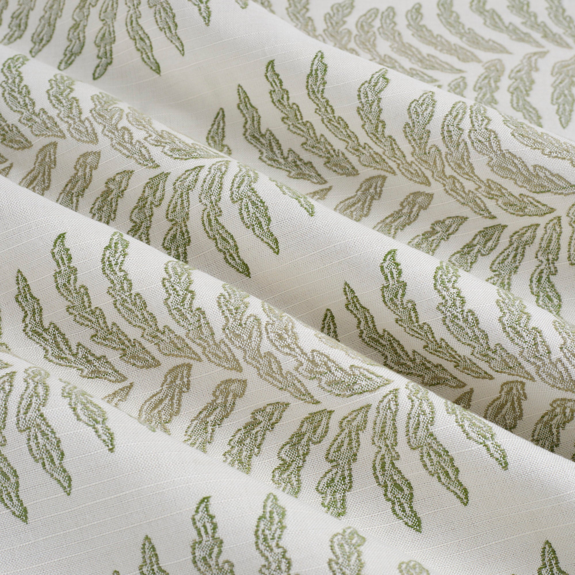 Tonic Living Swoon Sunbrella Sage performance fabric showing soft drape and movement in a sage green botanical stripe.