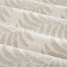 Tonic Living Swoon Sunbrella Sand performance fabric showing soft drape and movement in a beige botanical stripe.