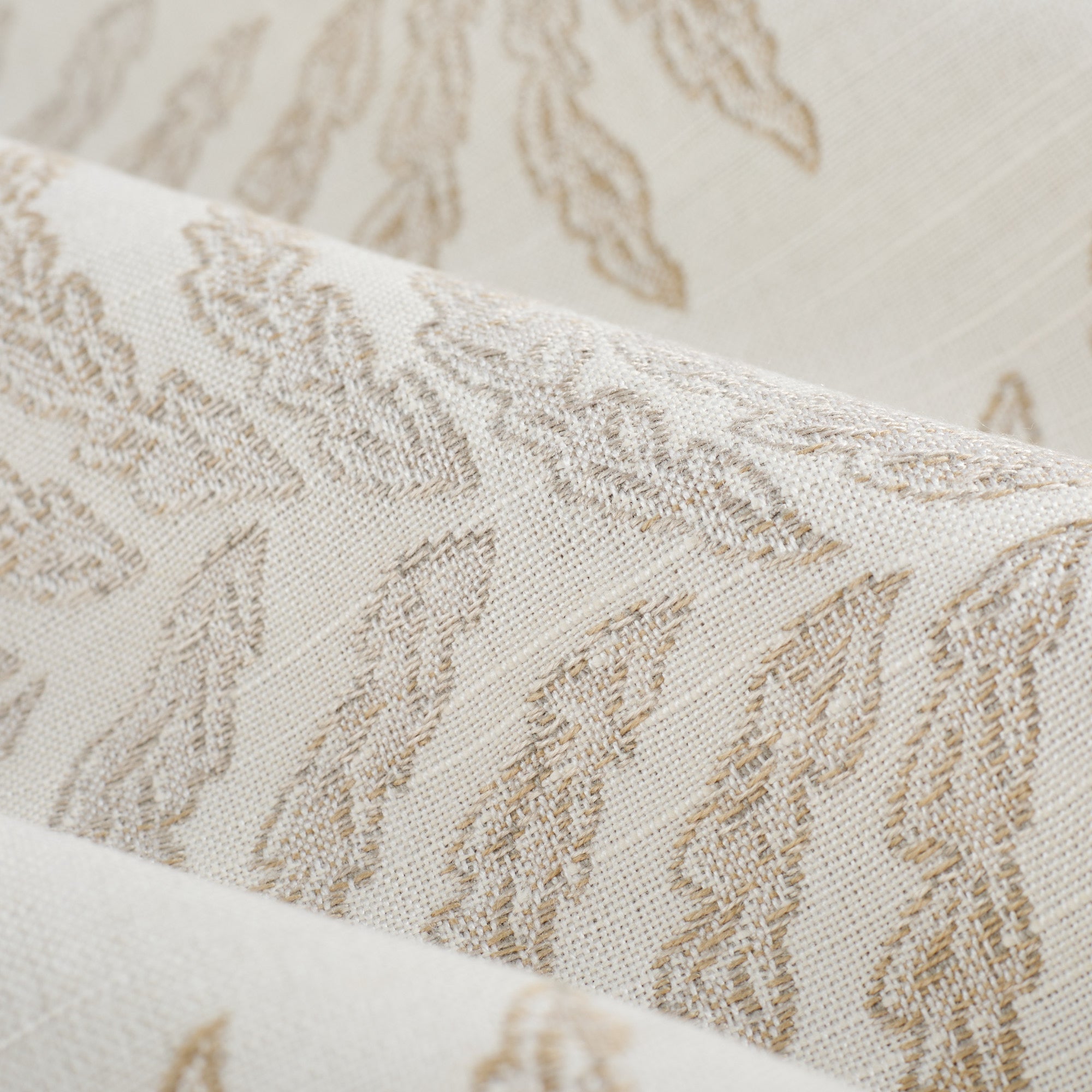 Close up of Tonic Living Swoon Sunbrella Sand fabric showing beige and white botanical stripe detail.
