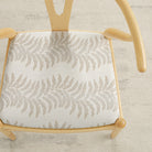 Tonic Living Swoon Sunbrella Sand indoor/outdoor upholstery fabric on a dining chair seat in neutral botanical stripe.