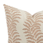 Close up of Tonic Living Swoon outdoor pillow showing terracotta and white botanical stripe detail.