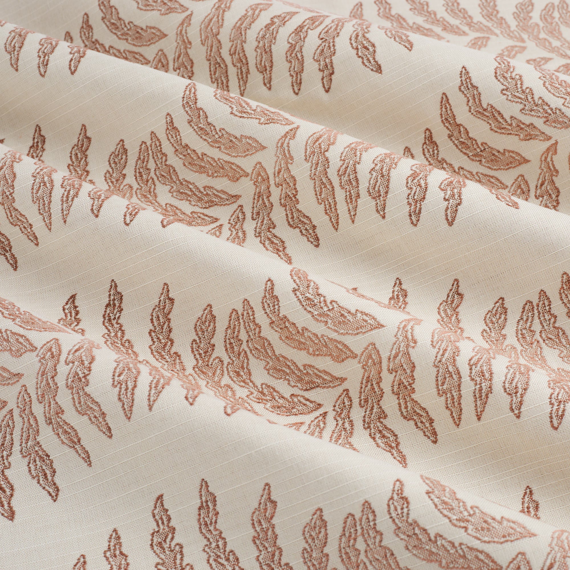 Tonic Living Swoon Sunbrella Terracotta performance fabric showing soft drape and movement in a terracotta botanical stripe.