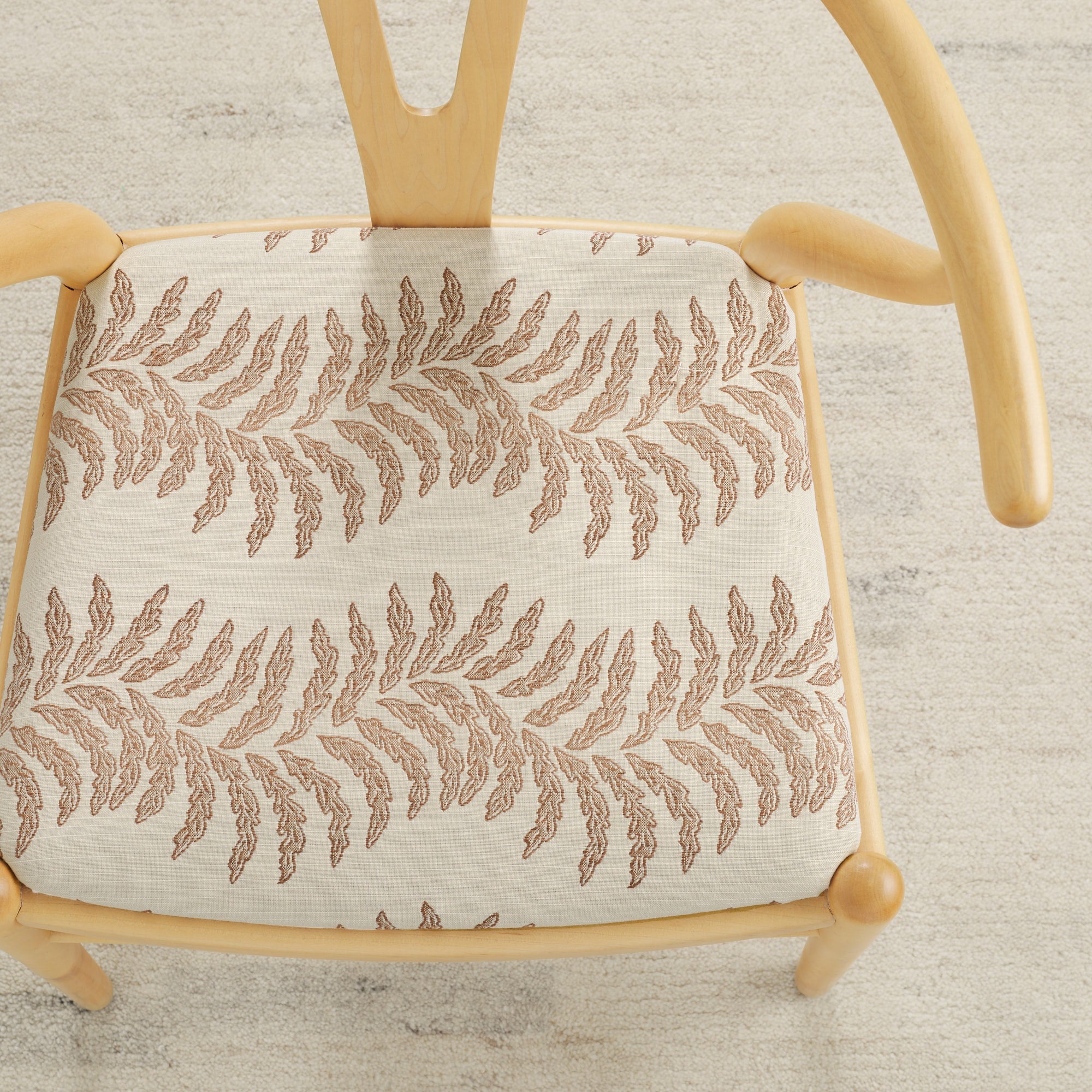 Tonic Living Swoon Sunbrella Terracotta indoor/outdoor upholstery fabric on a dining chair seat in terracotta botanical stripe.