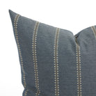 Close up of Tonic Living Talisman outdoor cushion showing denim blue fabric with raised stitch geometric stripe detail.