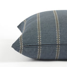 Side zipper detail of Tonic Living Talisman 22x22 outdoor toss pillow in dark blue with an embroidered stripe.