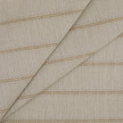 Tonic Living Talisman Sunbrella Outdoor Fabric in Sand, a neutral indoor/outdoor upholstery fabric with an embroidered stripe.