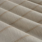 Tonic Living Talisman Sunbrella Sand performance fabric showing soft drape and movement in a neutral embroidered stripe.