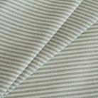 Tap Moss Sunbrella Outdoor Fabric, a soft green and white striped upholstery fabric from Tonic Living.