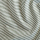 Tap Indoor/Outdoor upholstery fabric from Tonic Living, a mossy green and soft white upholstery fabric with a traditional ticking stripe pattern.