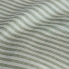Tap Moss, a sage and off-white indoor/outdoor fabric with classic ticking stripes.