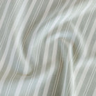 Tranquil Sage Sunbrella Outdoor Fabric from Tonic Living, a soft green and off-white striped home decor fabric.