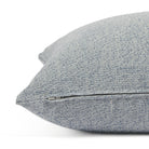 Side zipper detail of Tonic Living Troy 22x22 outdoor toss pillow in solid blue textured fabric.