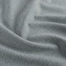Close up of Tonic Living Troy InsideOut Denim indoor/outdoor fabric showing rich blue linen-like texture.