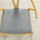 Tonic Living Troy InsideOut Denim indoor/outdoor upholstery fabric on a dining chair seat in textured blue fabric.