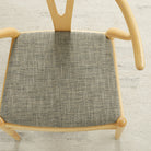 Tonic Living Troy InsideOut Sable performance upholstery fabric on a dining chair seat in black, brown, and beige tones.