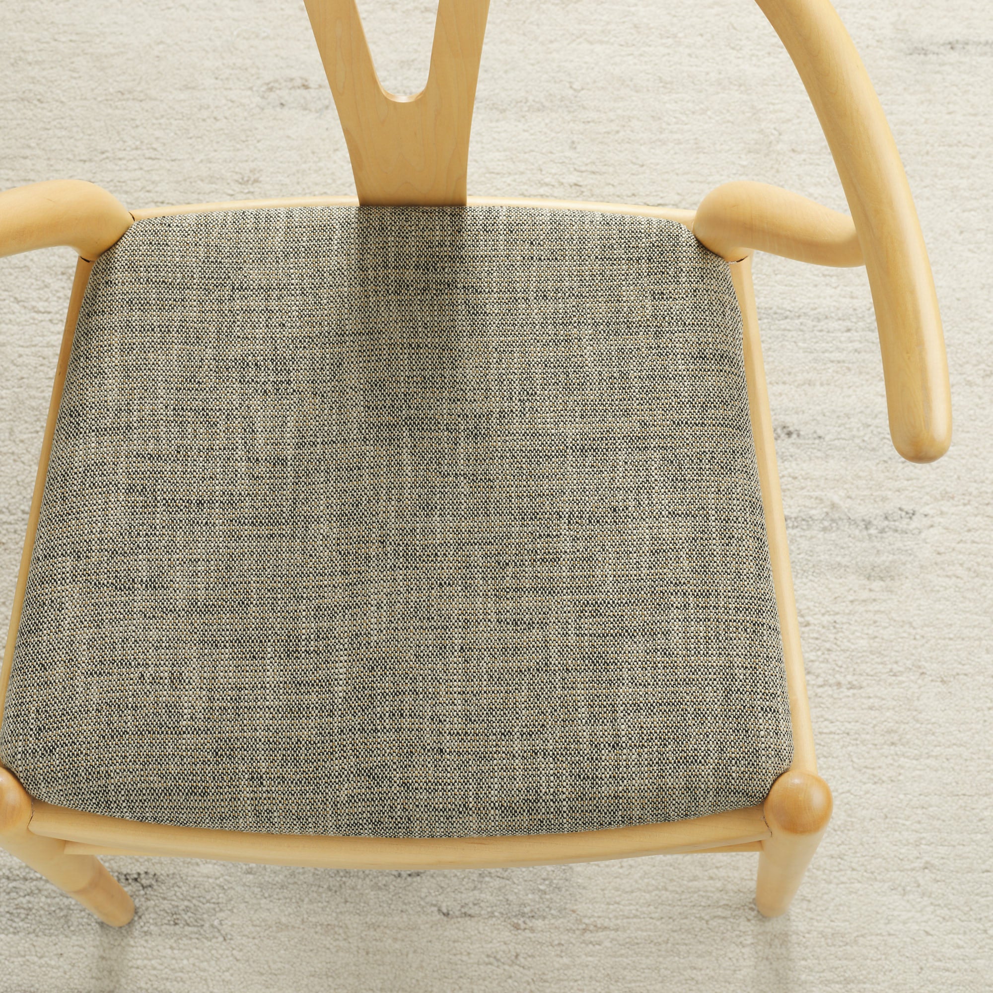 Tonic Living Troy InsideOut Sable performance upholstery fabric on a dining chair seat in black, brown, and beige tones.