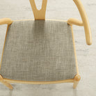 Tonic Living Troy InsideOut Tweed indoor/outdoor upholstery fabric on a dining chair seat in beige and brown tones.