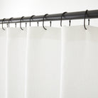 Tonic Living Tuscany Linen Shower Curtain in Oyster, a warm white linen shower curtain hanging from black curtain rings.