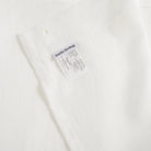 Inside top hem of Tonic Living Tuscany Linen Shower Curtain in Oyster showing the buttonhole top construction and Tonic Living label.
