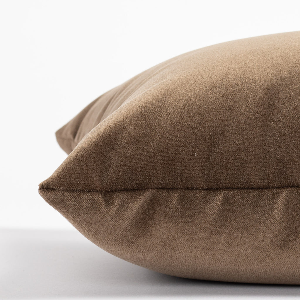 a rich brown velvet lumbar pillow - close up side view