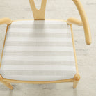 Tonic Living Vera InsideOut Pearl indoor/outdoor upholstery fabric on a dining chair seat in soft white stripe.