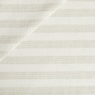 Tonic Living Vera InsideOut Fabric in Pearl, a soft white indoor/outdoor upholstery fabric with subtle textured stripes.