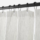 Close up of Tonic Living Verona Stripe Linen Shower Curtain showing buttonhole top in black and white stripe.