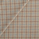 Vesper Paprika houndstooth upholstery fabric in beige, blue, and rust by Tonic Living.