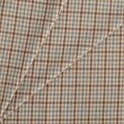 Vesper Paprika houndstooth check fabric in beige, blue, and brown for upholstery and decor.